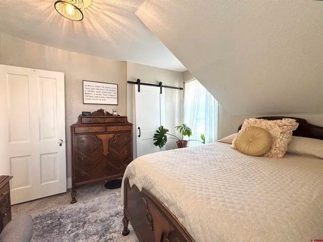 a bedroom with a bed and a dresser