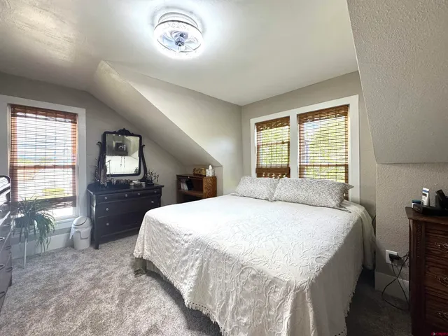 a bedroom with a large bed and a tv