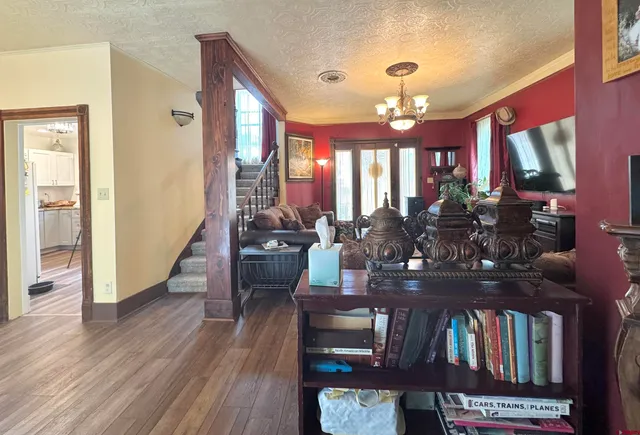 a view of a dining room with furniture and a chandelier