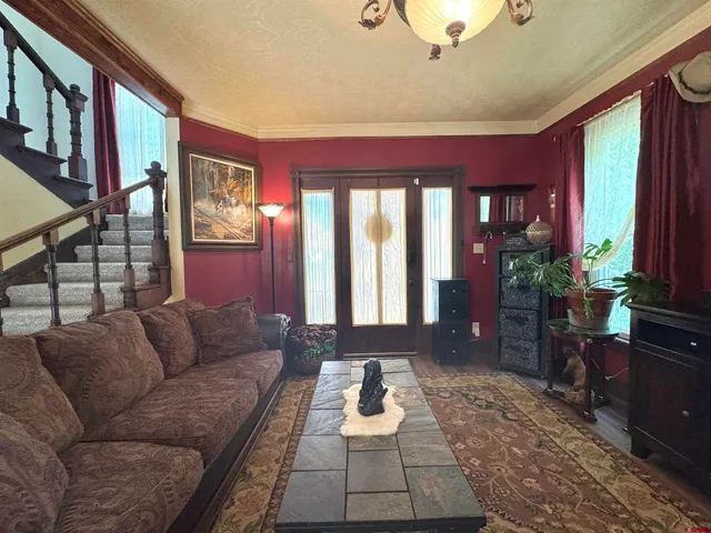 a living room with furniture and a potted plant