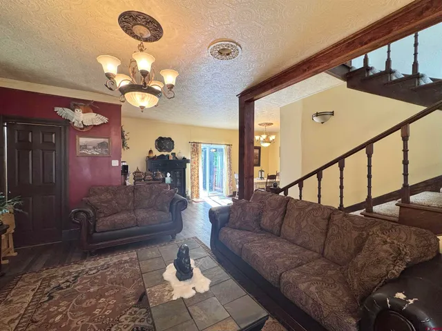 a living room with furniture chandelier and a chandelier