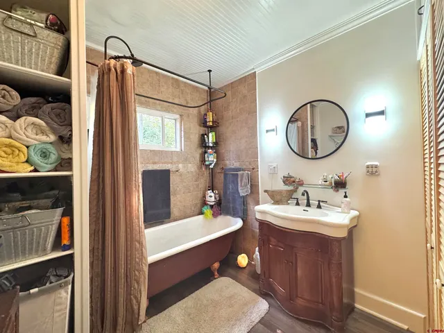 a bathroom with a double vanity sink mirror and tub
