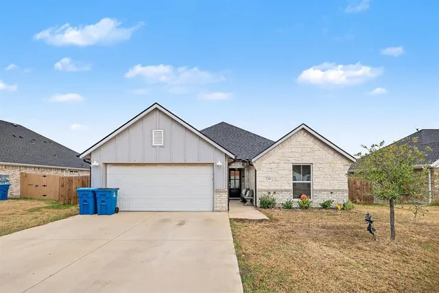 a view of a house with a yard and garage