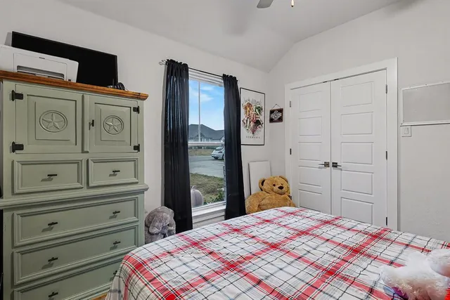 a bedroom with a bed and a dresser