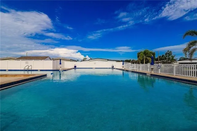 a view of a house with a yard and potted plants