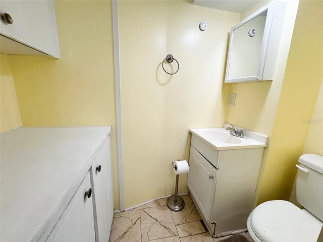 a view of a room with wooden floor and a window