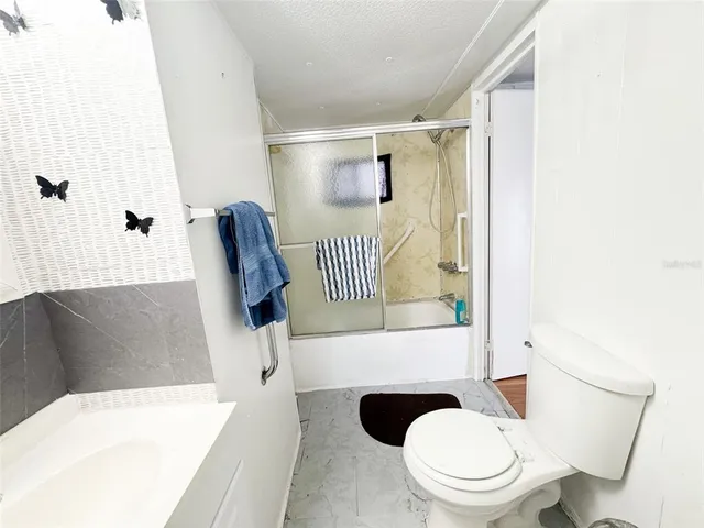 a view of a livingroom with wooden floor and a window
