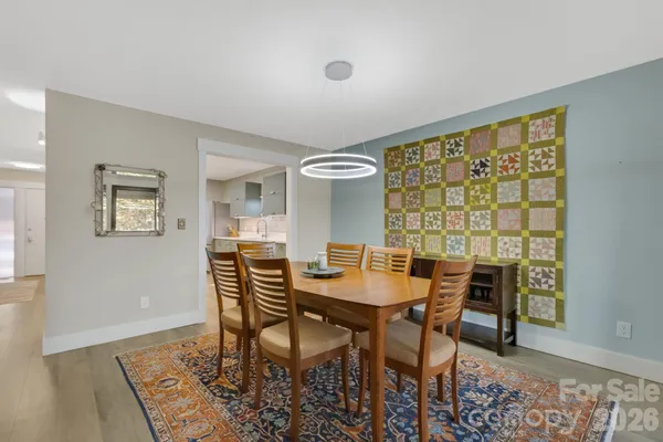 a dining room with furniture a fireplace and wooden floor