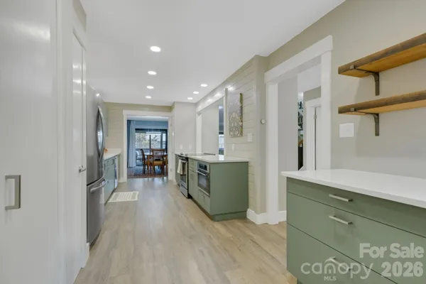 a dining room with chairs and view kitchen