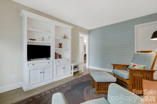 a living room with furniture a window and a table