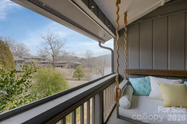 a bedroom with a bed a couch and a potted plant