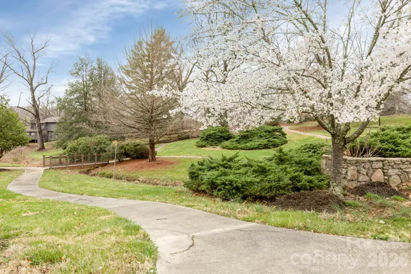 a spacious bedroom with a large bed and a flat screen tv