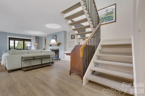 a spacious bedroom with a bed and a chandelier