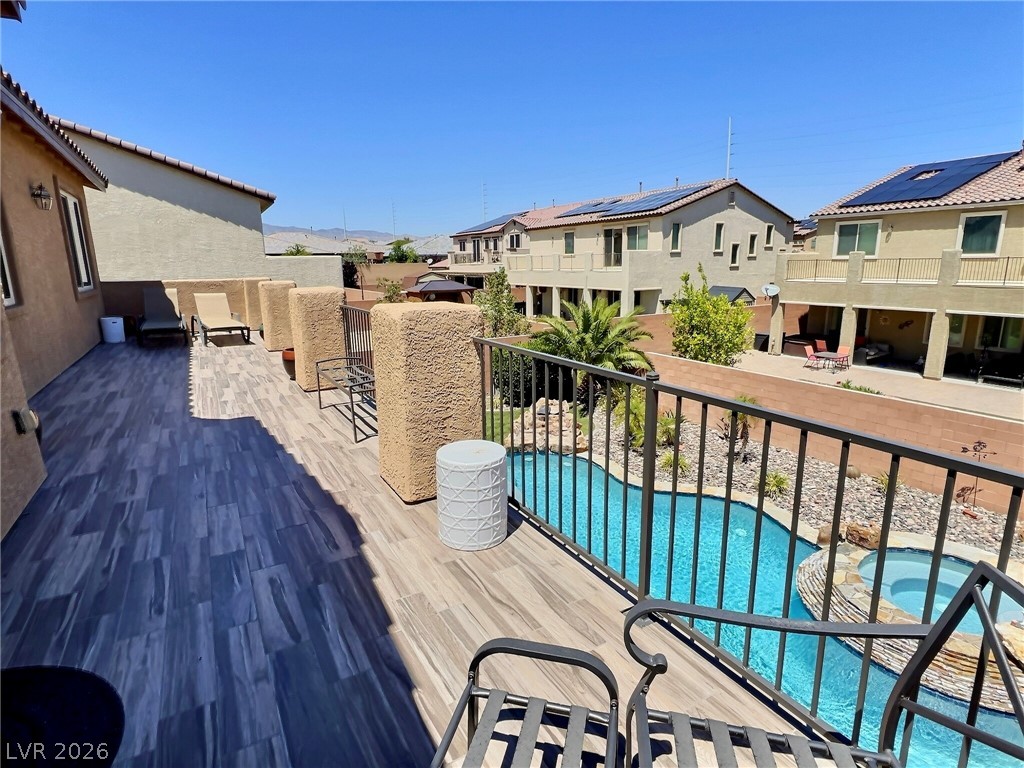 9724 University Ridge Avenue Las Vegas, NV 89149 - Photo 37 of 61 Enjoy outdoor leisure on this private deck, featuring views of the adjacent pool and spa.