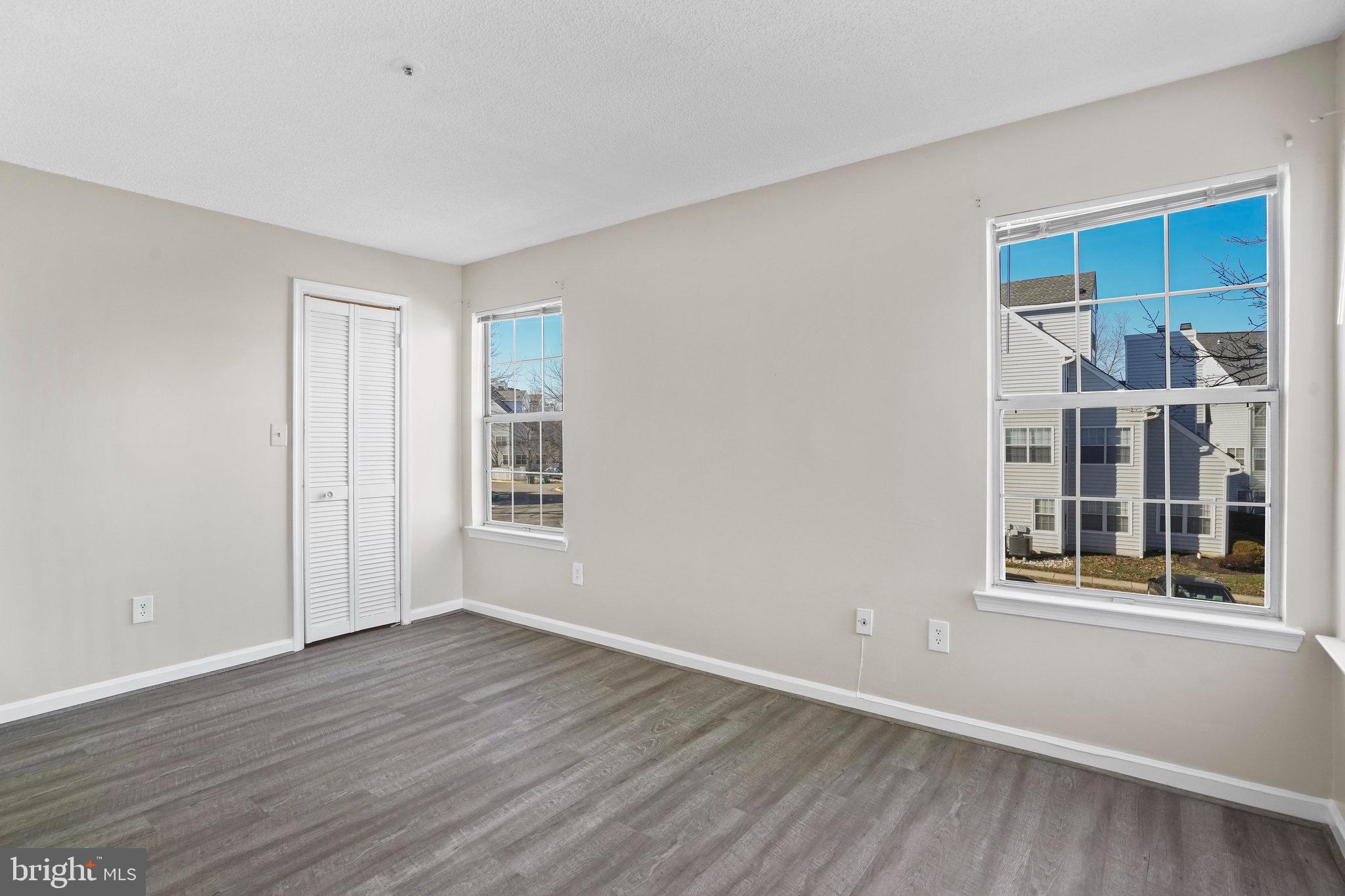 14023 Vista Drive, Unit 89 Laurel, MD 20707 - Photo 11 of 26 a view of an empty room with wooden floor and a window