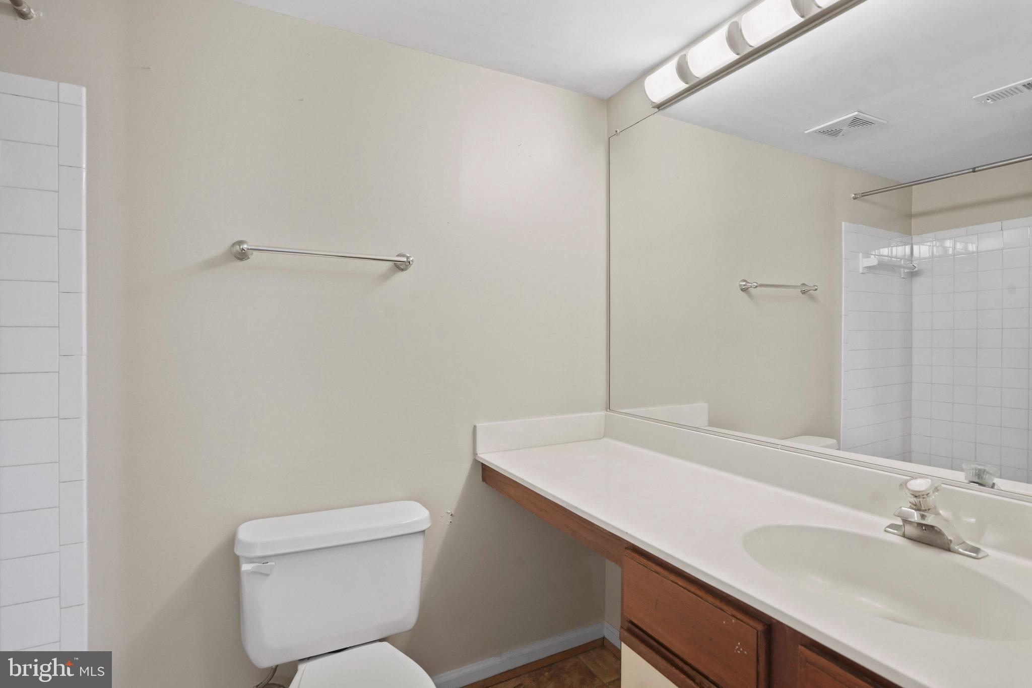 14023 Vista Drive, Unit 89 Laurel, MD 20707 - Photo 14 of 26 a bathroom with a sink a toilet and shower