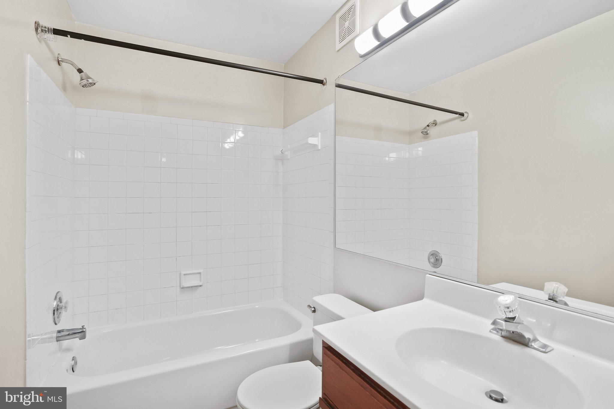 14023 Vista Drive, Unit 89 Laurel, MD 20707 - Photo 17 of 26 a bathroom with a sink toilet and shower