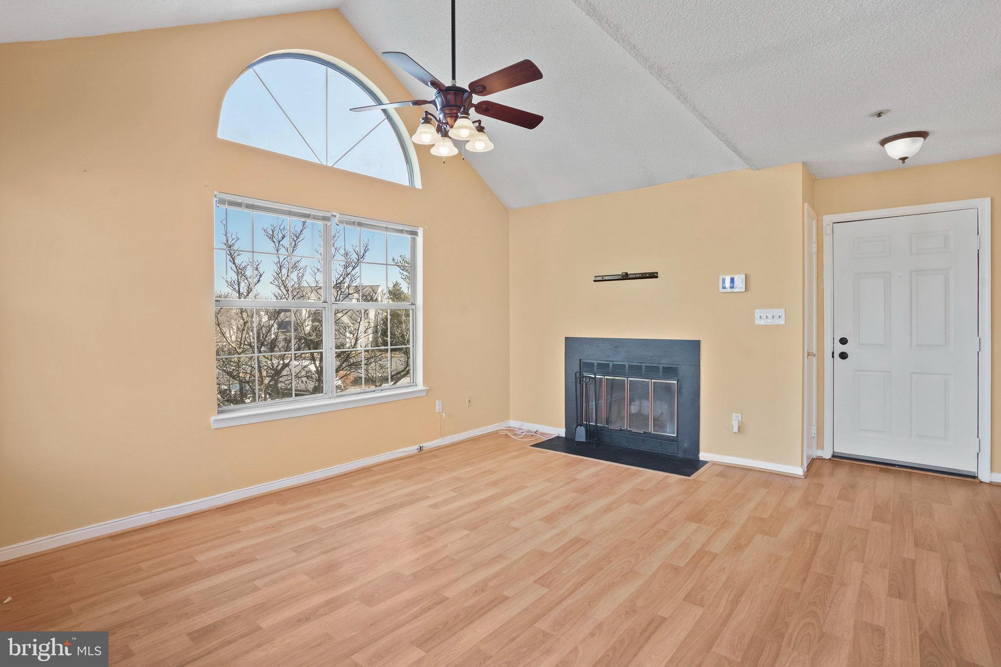 14023 Vista Drive, Unit 89 Laurel, MD 20707 - Photo 2 of 26 an empty room with wooden floor closet and windows