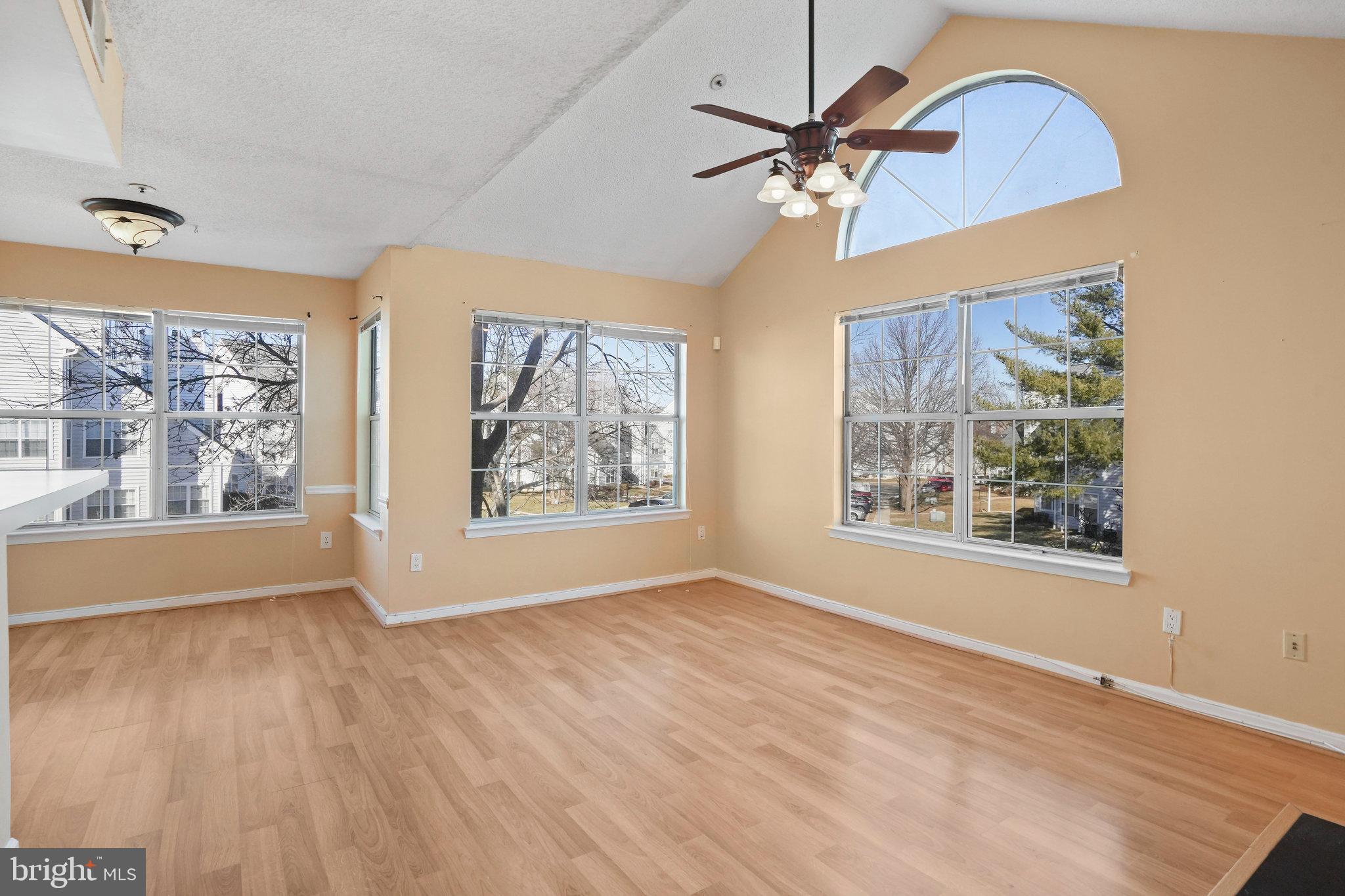 14023 Vista Drive, Unit 89 Laurel, MD 20707 - Photo 3 of 26 a view of an empty room with wooden floor and a window