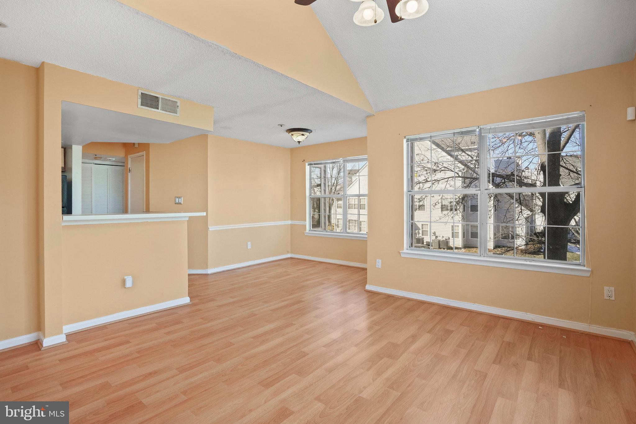 14023 Vista Drive, Unit 89 Laurel, MD 20707 - Photo 4 of 26 an empty room with wooden floor and windows