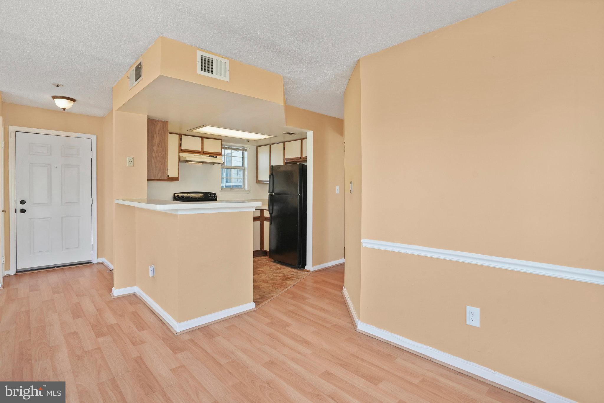 14023 Vista Drive, Unit 89 Laurel, MD 20707 - Photo 6 of 26 a view of a kitchen with wooden floor and electronic appliances