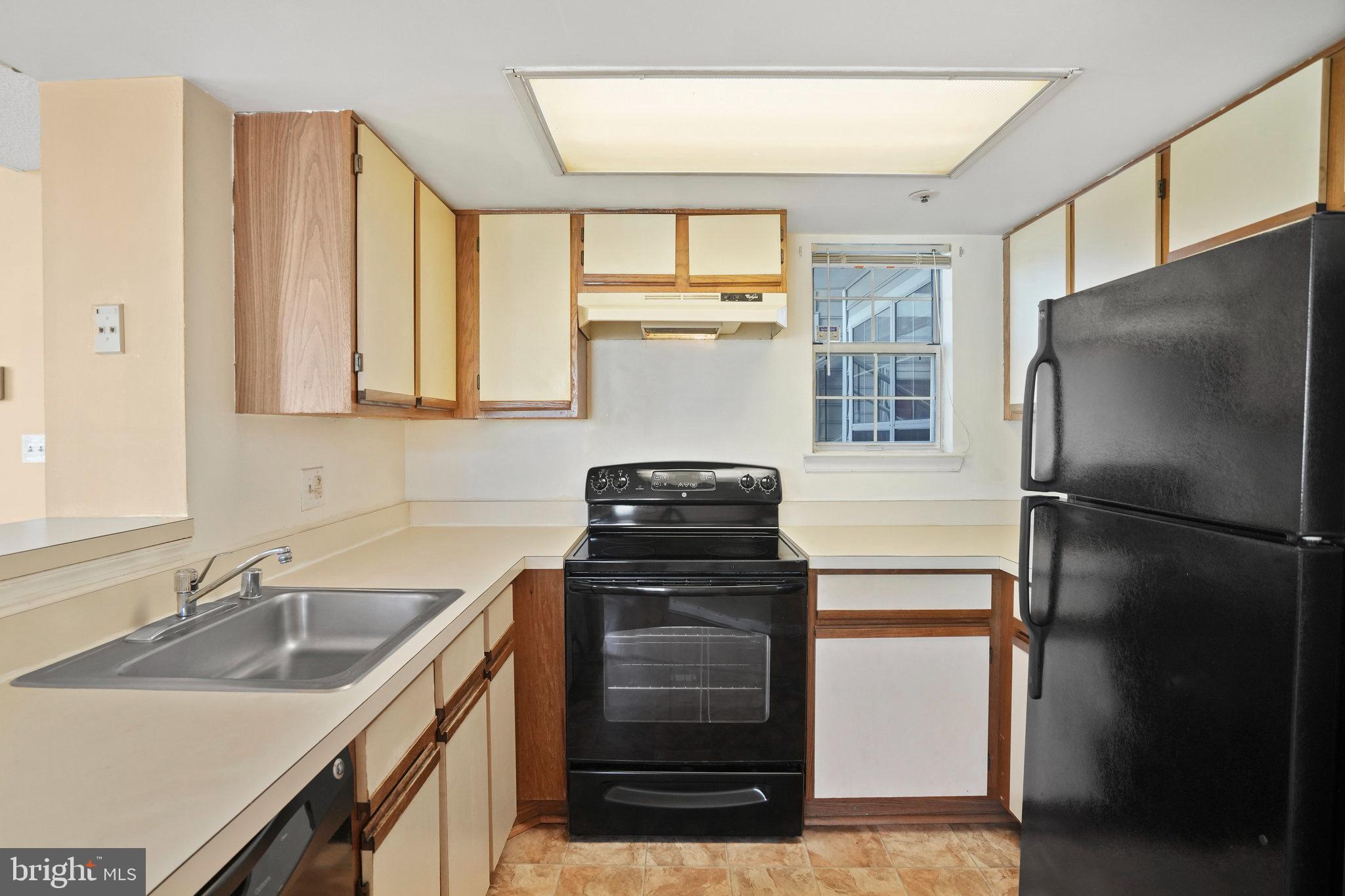 14023 Vista Drive, Unit 89 Laurel, MD 20707 - Photo 8 of 26 a kitchen with a refrigerator and a sink