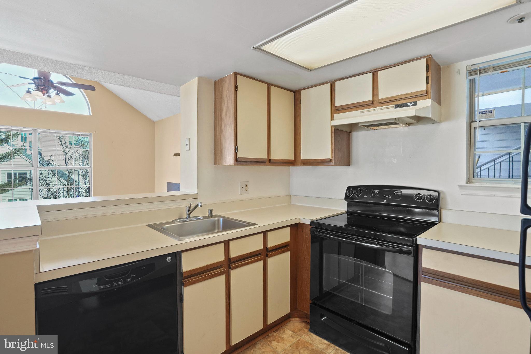 14023 Vista Drive, Unit 89 Laurel, MD 20707 - Photo 9 of 26 a kitchen with a sink stove and cabinets