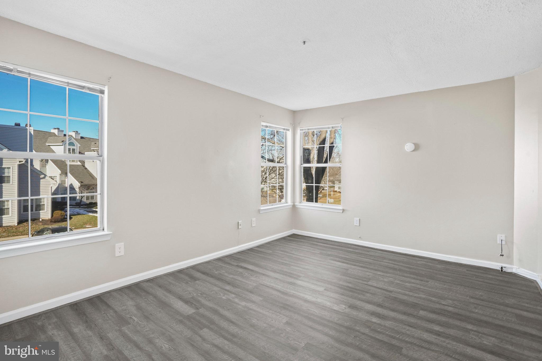 14023 Vista Drive, Unit 89 Laurel, MD 20707 - Photo 10 of 26 a view of an empty room with window and wooden floor
