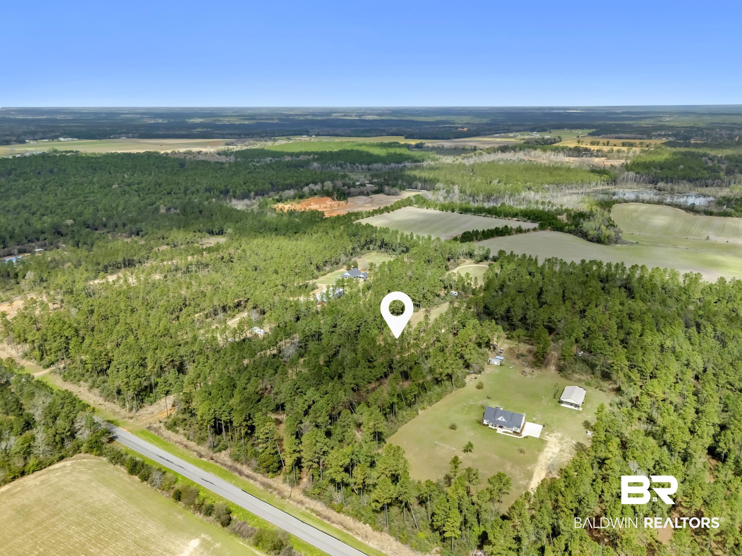 0 Gardner Road Elberta, AL 36530 - Photo 4 of 19 Aerial view of sparsely populated area with a heavily wooded area