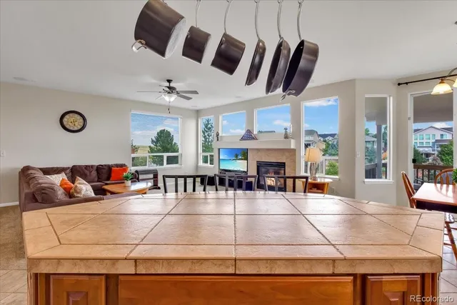 a living room with furniture a flat screen tv and a table