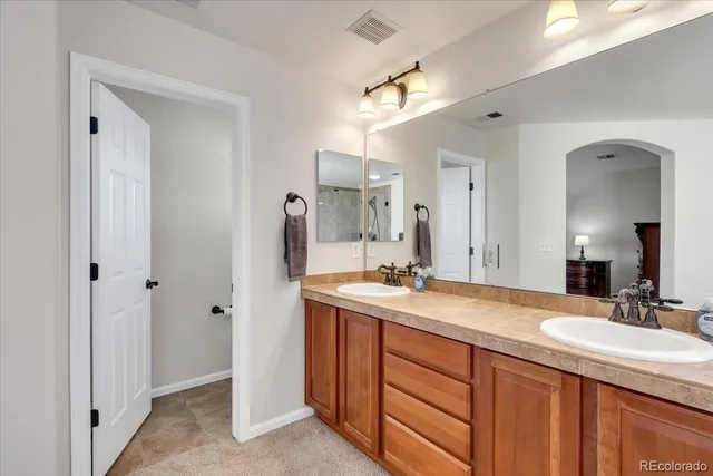 a bathroom with 2 sink and a mirror