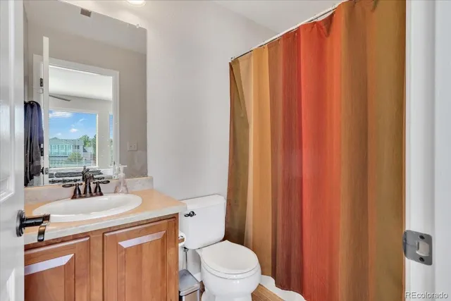 a bathroom with a sink a toilet and mirror