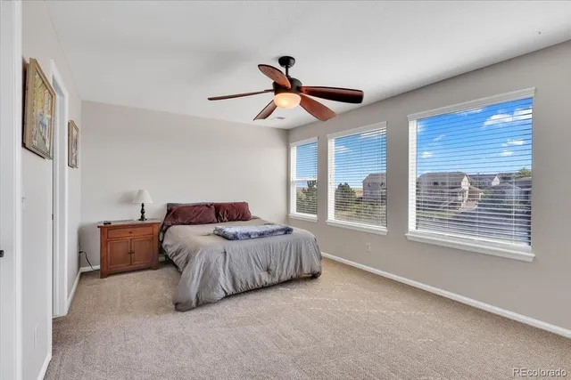 a living room with a bed furniture and a large window