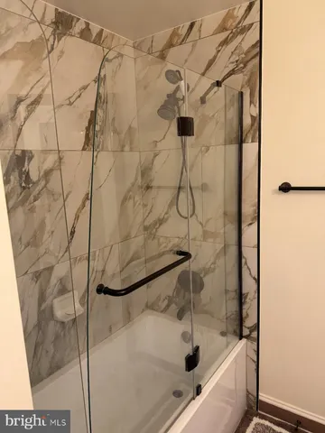 a bedroom with a bed dresser and window