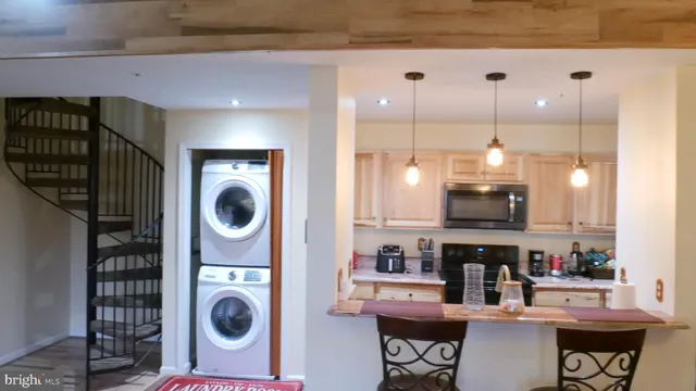 a kitchen with stainless steel appliances kitchen island a stove a sink and a refrigerator