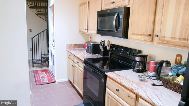 a kitchen with a sink stove and microwave