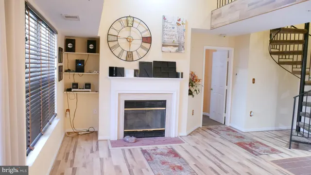 a view of a hallway with wooden floor and a fireplace