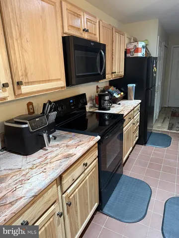 a kitchen with a sink stove and refrigerator
