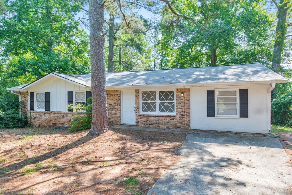 a front view of a house with a garden and yard