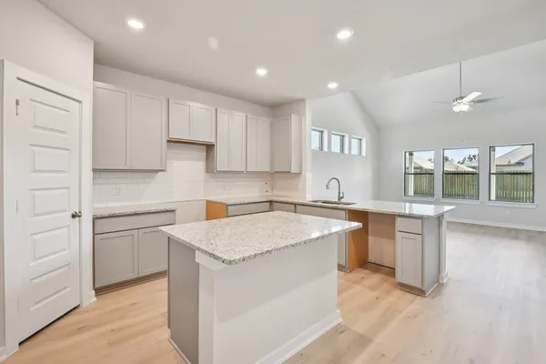 a bathroom with a granite countertop sink a mirror and