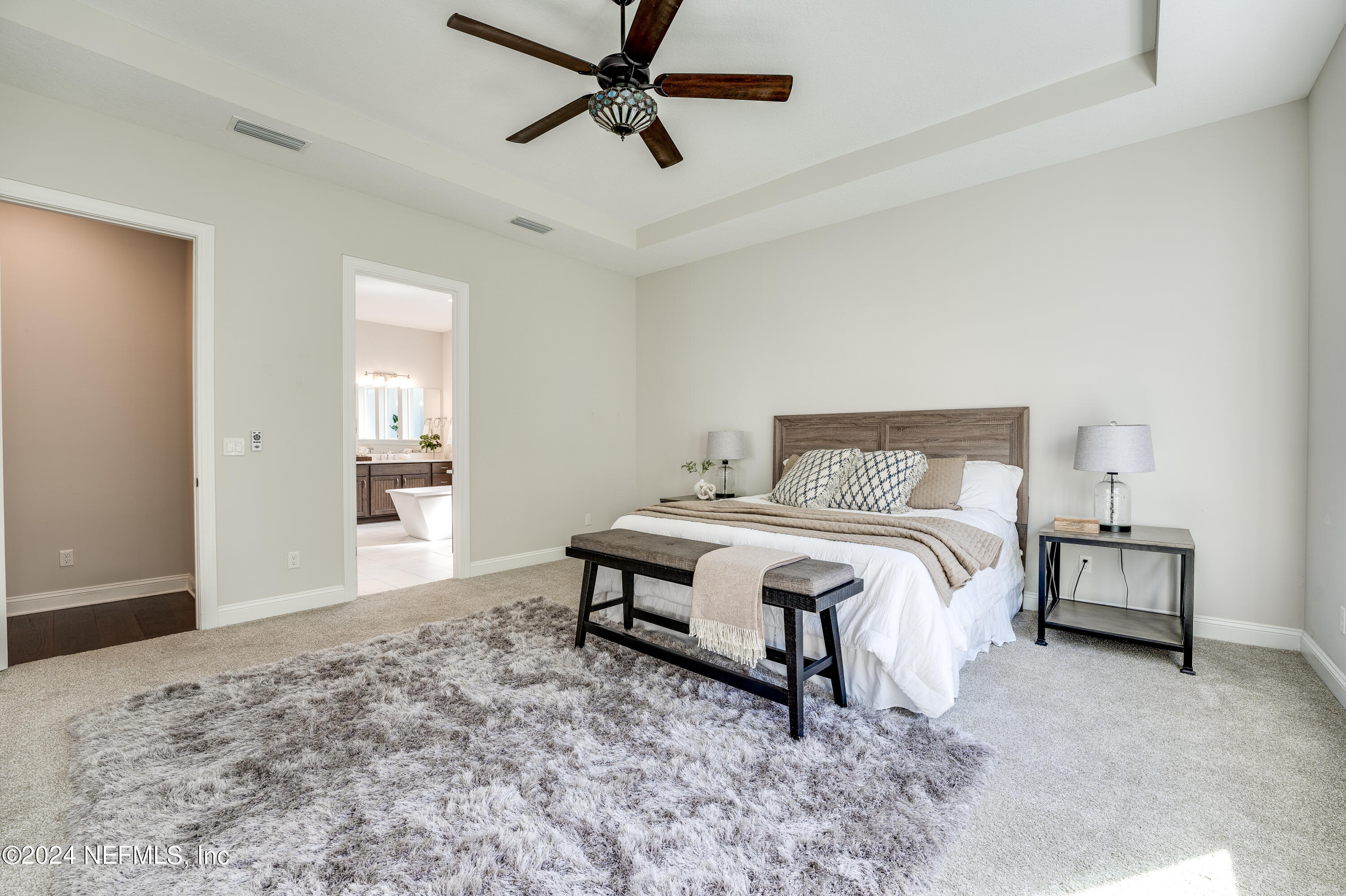 257 Glenneyre Circle St. Augustine, FL 32092 - Photo 25 of 98 a bedroom with a bed and a cabinets