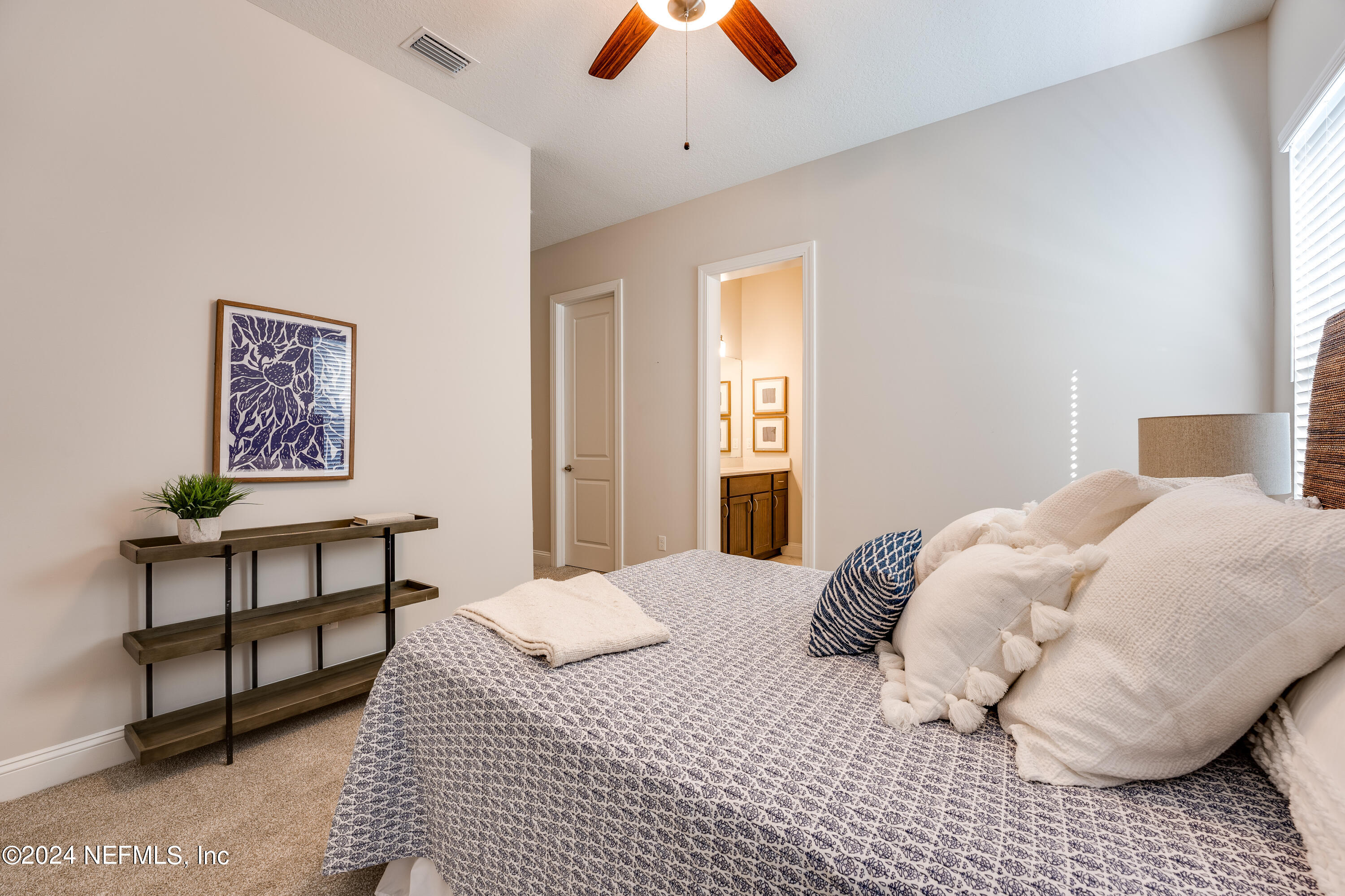 257 Glenneyre Circle St. Augustine, FL 32092 - Photo 36 of 98 a bedroom with a bed and a lamp