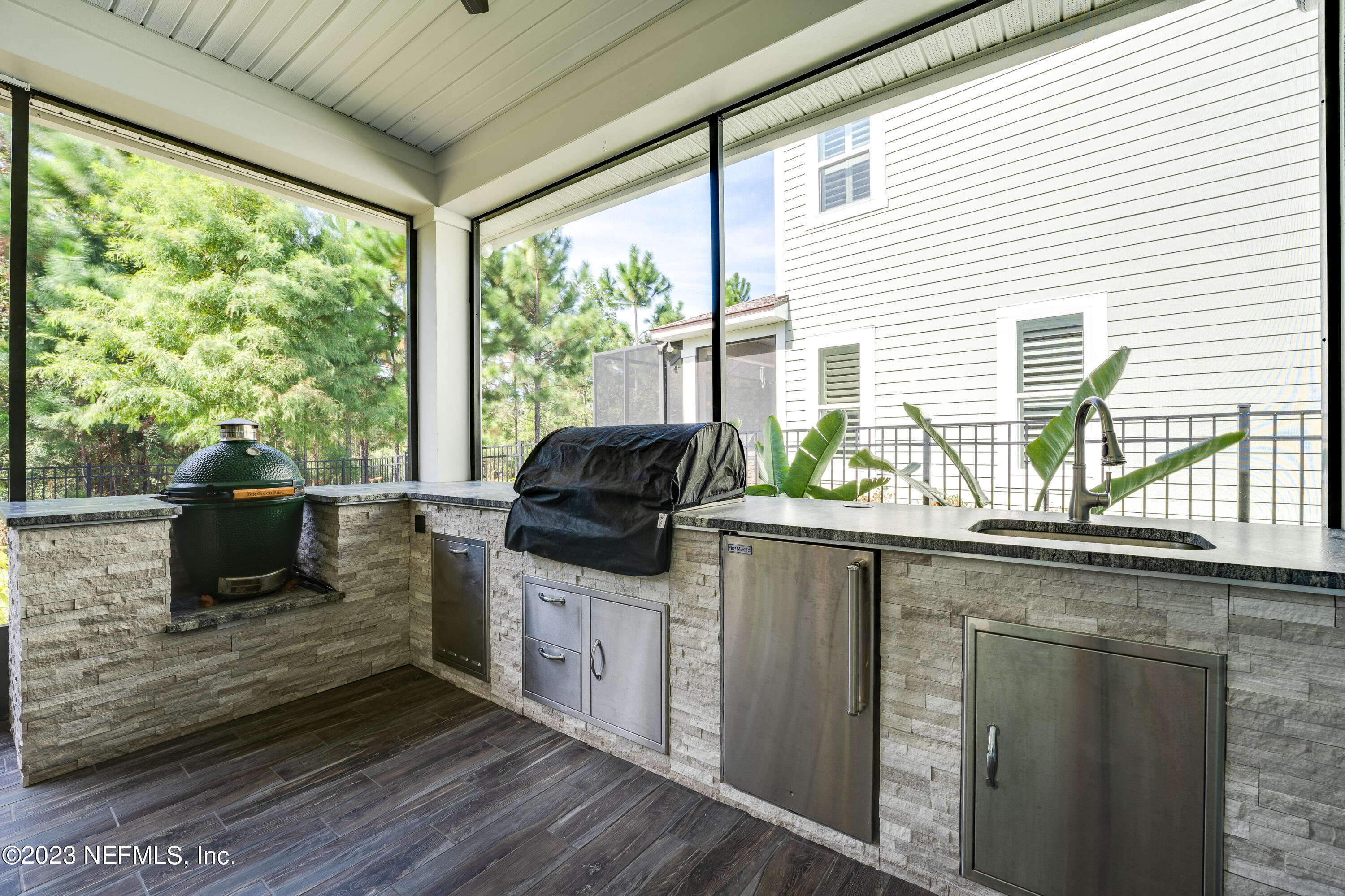 257 Glenneyre Circle St. Augustine, FL 32092 - Photo 50 of 98 a kitchen with a sink and wooden cabinets