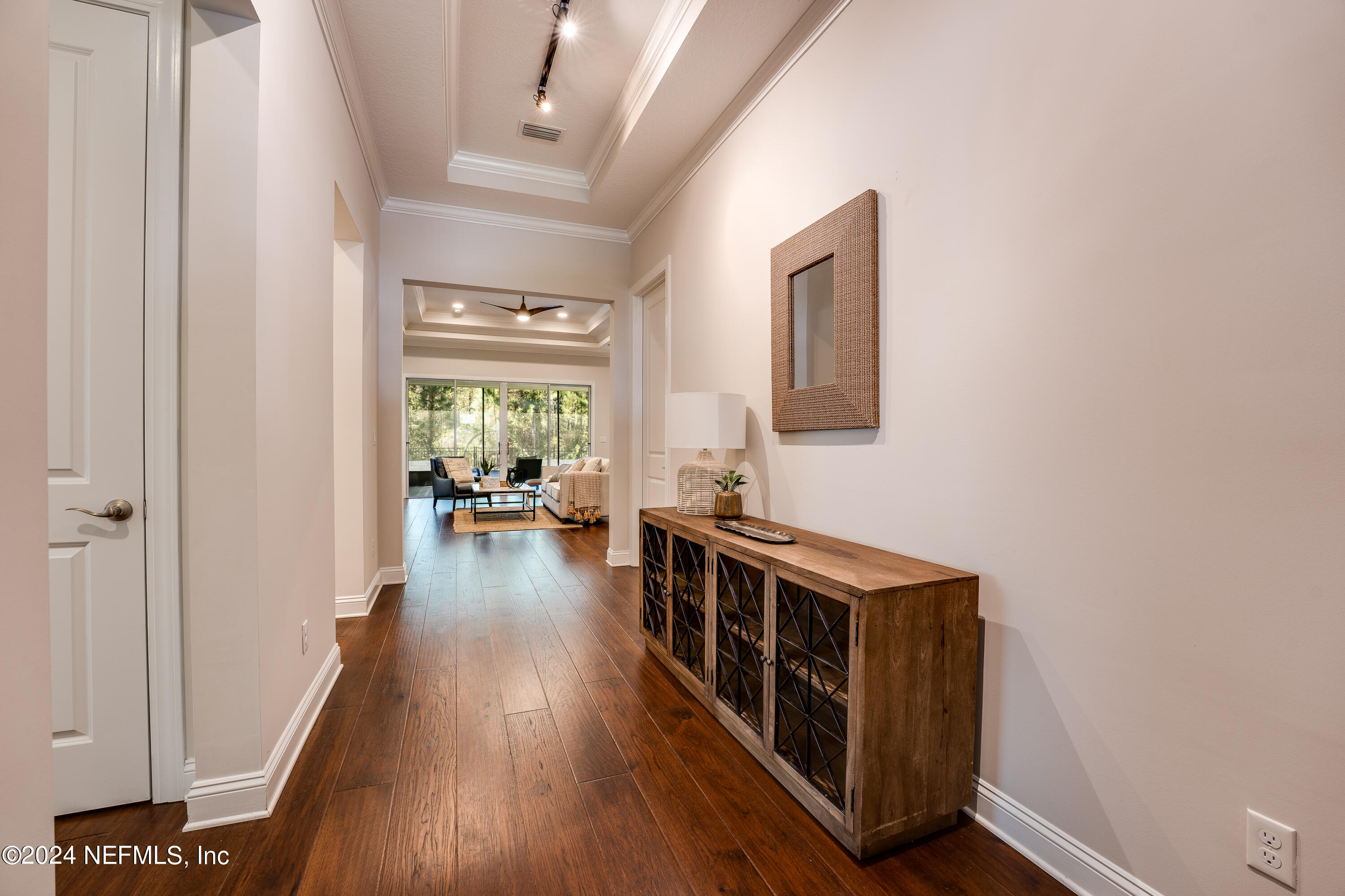 257 Glenneyre Circle St. Augustine, FL 32092 - Photo 8 of 98 a hallway with wooden floor windows and a livingroom