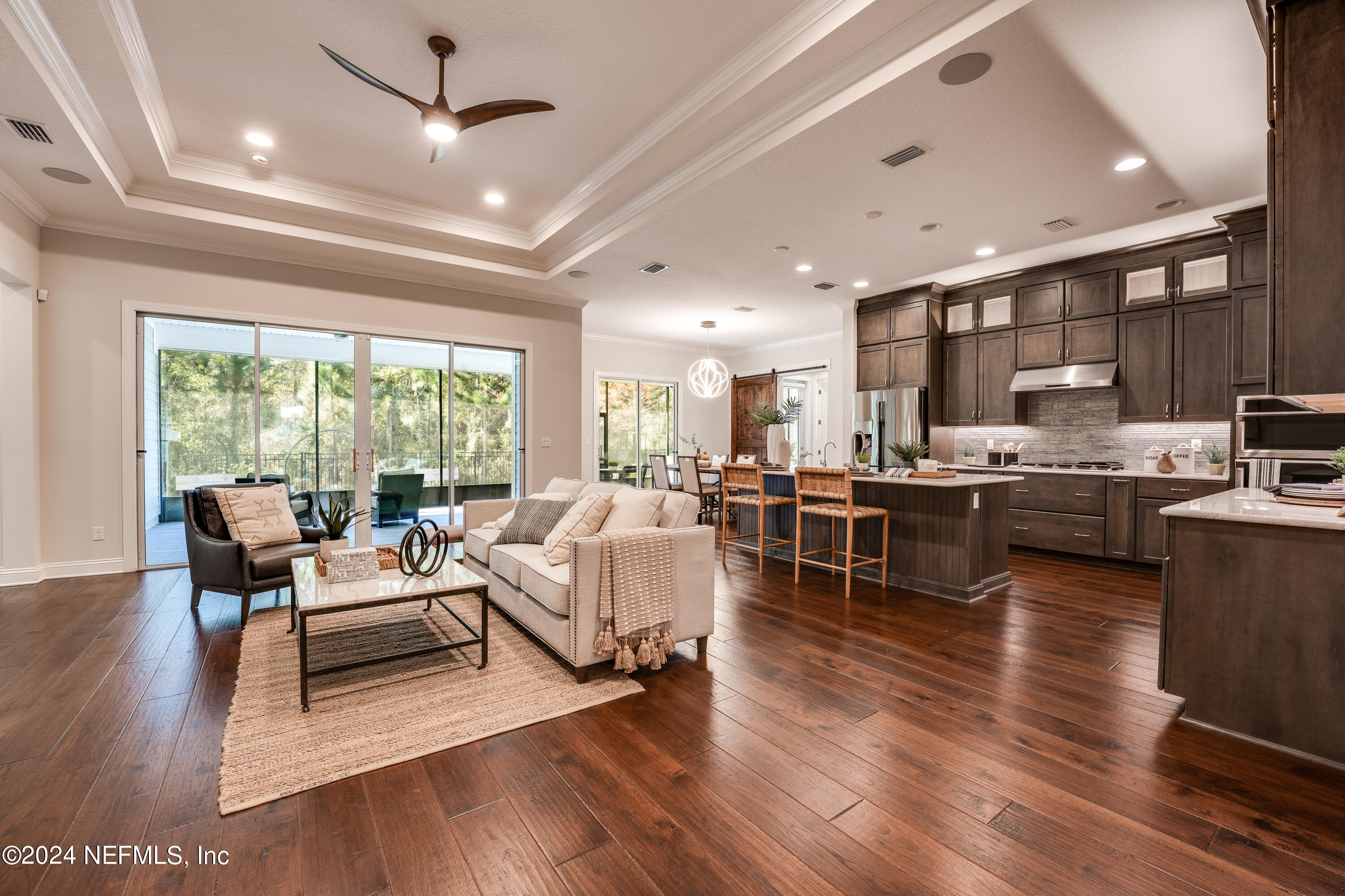 257 Glenneyre Circle St. Augustine, FL 32092 - Photo 10 of 98 a living room with stainless steel appliances furniture wooden floor and a kitchen view