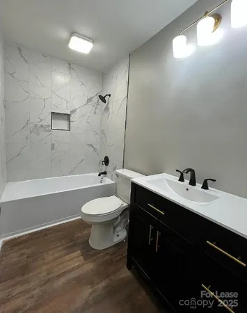a bathroom with a double vanity sink toilet and shower