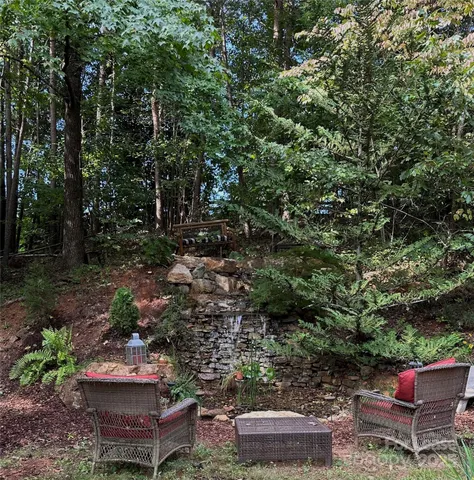 a view of a backyard with furniture and plants