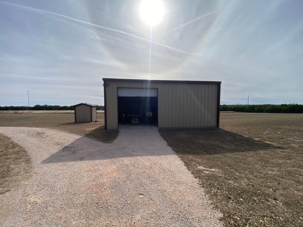 1320 County Road 304 Bertram, TX 78605 - Photo 18 of 38 a view of a livingroom with an empty space and wooden floor