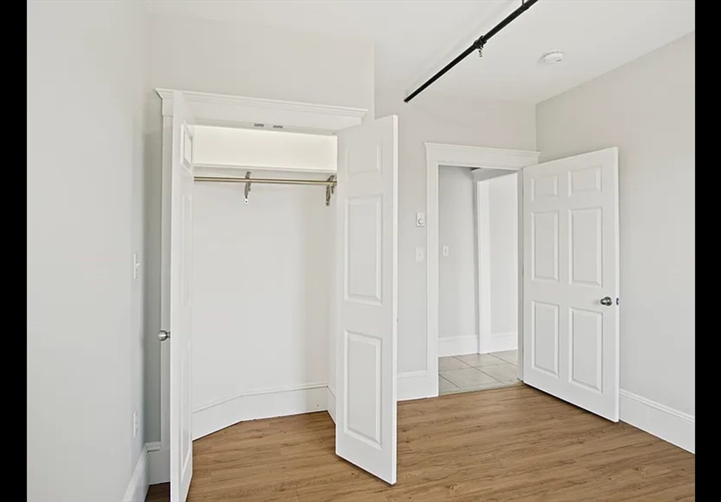 2 Redfield Street, Unit 2 Boston, MA 02122 - Photo 12 of 14 a view of an empty room with wooden floor