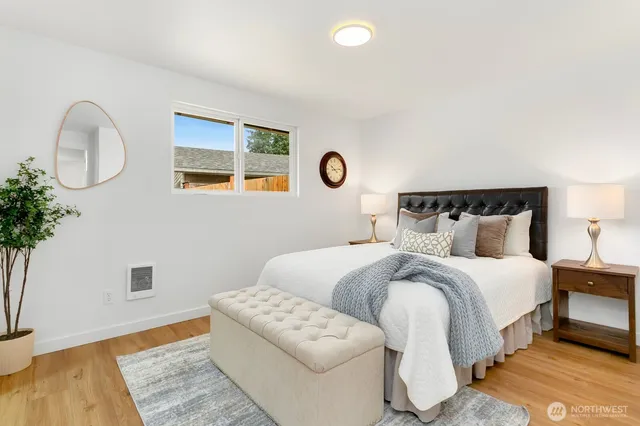 a bedroom with a bed and a potted plant